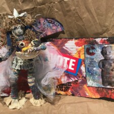 BECKY HUNGER
I received my "art seed" packet from Fran. It included a cotton ball, wire, colorful string, blue ribbon, a small shell, a small piece of fabric and white netting. I immediately thought of making an affirmation doll with the cotton ball as the head. I enjoyed the process and when the doll was finished decided she needed to be actively doing something. I made a large bowl of fruit for her to hold as an offering. I decided she was a muse bringing peace into a chaotic world. With Covid 19 and police shootings filling our world narrative, she represented a generous and supportive part of humankind that will help pull us through the chaos.