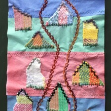 SALLY LACKNER
"The Road Goes to Nobody’s House"
Size: 9.5”X25"
The background is made from machine stitched together dye color catcher sheets. Until they would come out of the washer, I never knew what color they would be. Houses were made from pieces of handwoven fabric. Details such as roofing, grass and the road were added by hand embroidery stitches It was fun to work on this piece during the Spring of the quarantine, sometimes only a few minutes at a time.