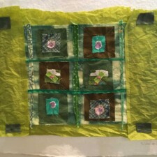 DEBBY LEVINE
It’s the style I’ve been working in lately where I just have fun stitching fabric scraps together. It’s mounted on handmade paper. The green paper is some tissue paper I found around. I always have trouble figuring out how to display pieces so this one has gotten way further than most of what I do does.
