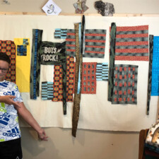 BETSY WHITTEMORE
This summer had grandkids (9 and 11), and they both really loved putting fabrics together and using my machine!!
I’m making a big quilt for my grandson, 11, who is very attached to his baby blanket! I know! So he and I are collaborating of incorporating it into a big quilt for his full size bed. He chose and approved of the fabrics. His blanket is a crib size fleece camouflage, with “Boys Rock” appliquéd on it. It’s going to be very cool. And it is imbued with a lot of love and spirit.